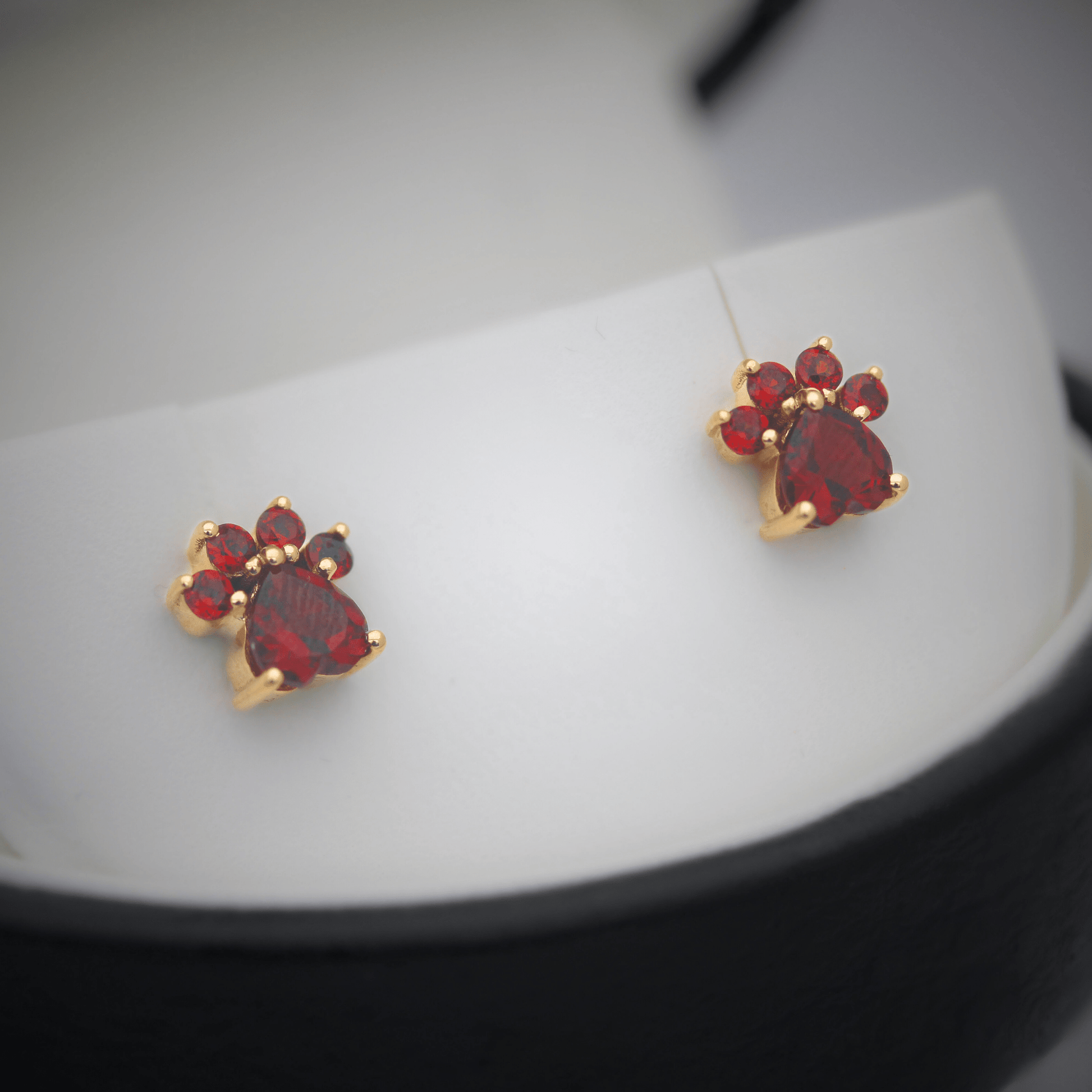 14K Garnet Paw Studs Angled Display View Zoomed